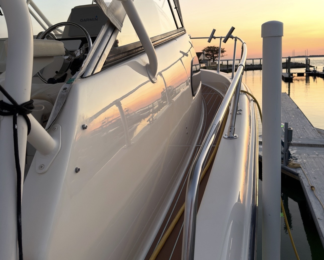 Ceramic coated boat reflecting a coastal sunset